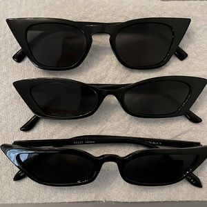 Three pairs of black plastic sunglasses.